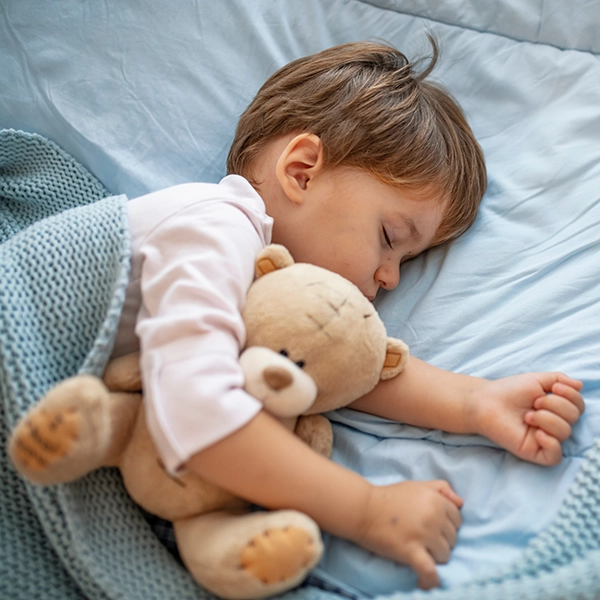 Das Kind schläft zufrieden im Bett